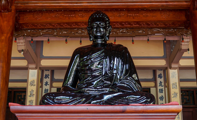 Bên trong chánh điện còn đặt một tượng Phật bằng đồng ngồi thuyết pháp, cao 1,6 m, nặng 700 kg.